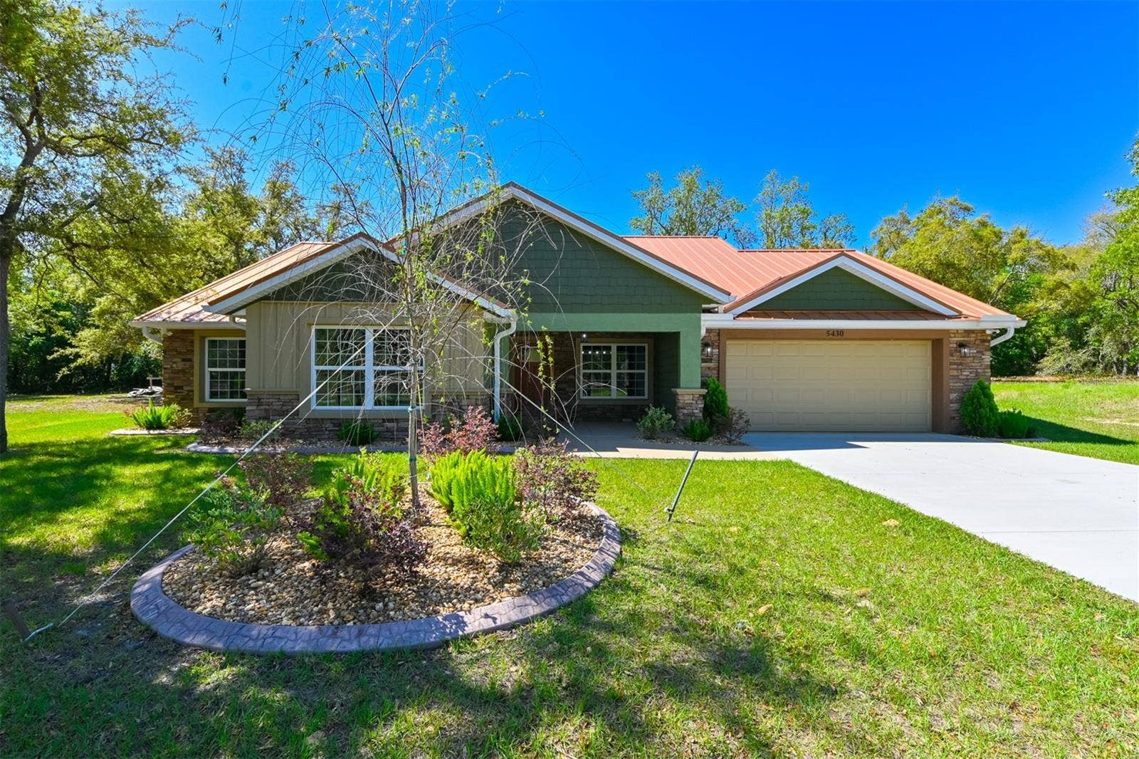 5430 W TORTUGA LOOP, Lecanto, FL 34461 Front view, spacious driveway