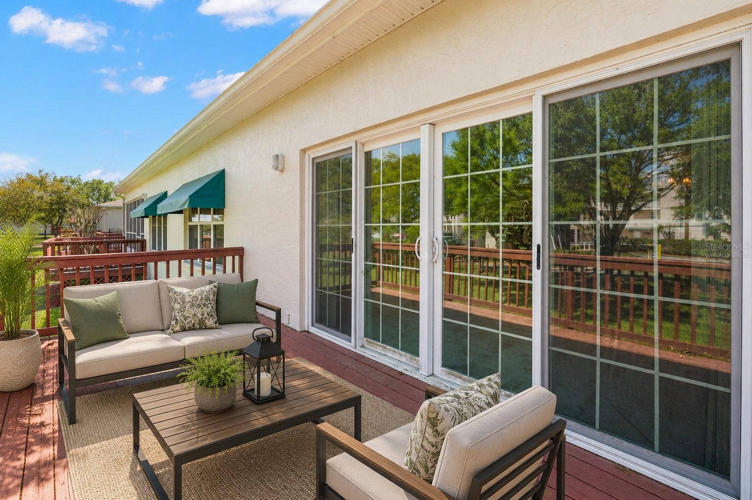 Spacious rear deck with direct access from the living room, offering a generous outdoor area for seating, dining, or creating your own outdoor retreat. This photo has been virtually staged.