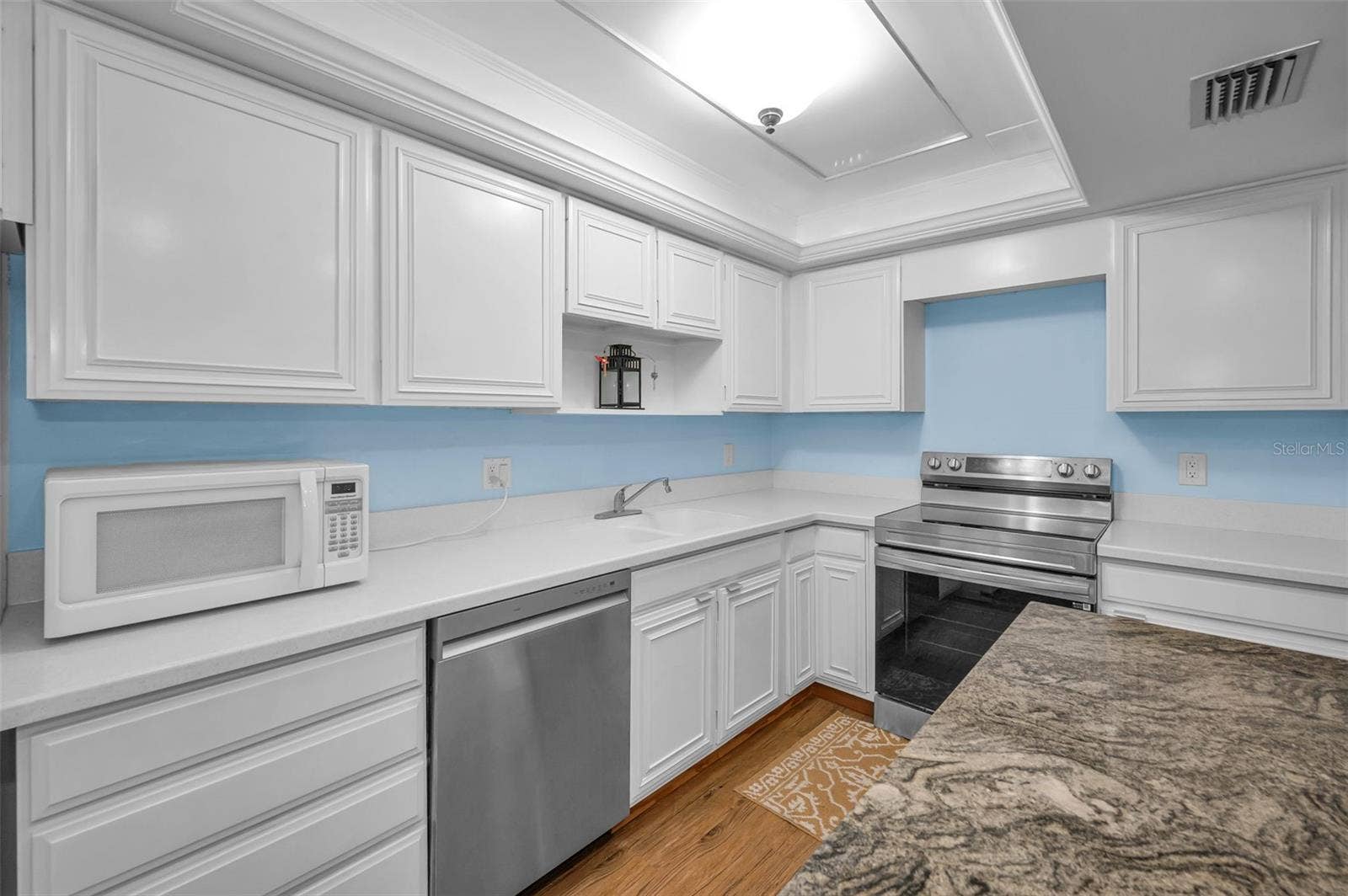 A beautifully refreshed coastal-contemporary kitchen featuring a new range and dishwasher.