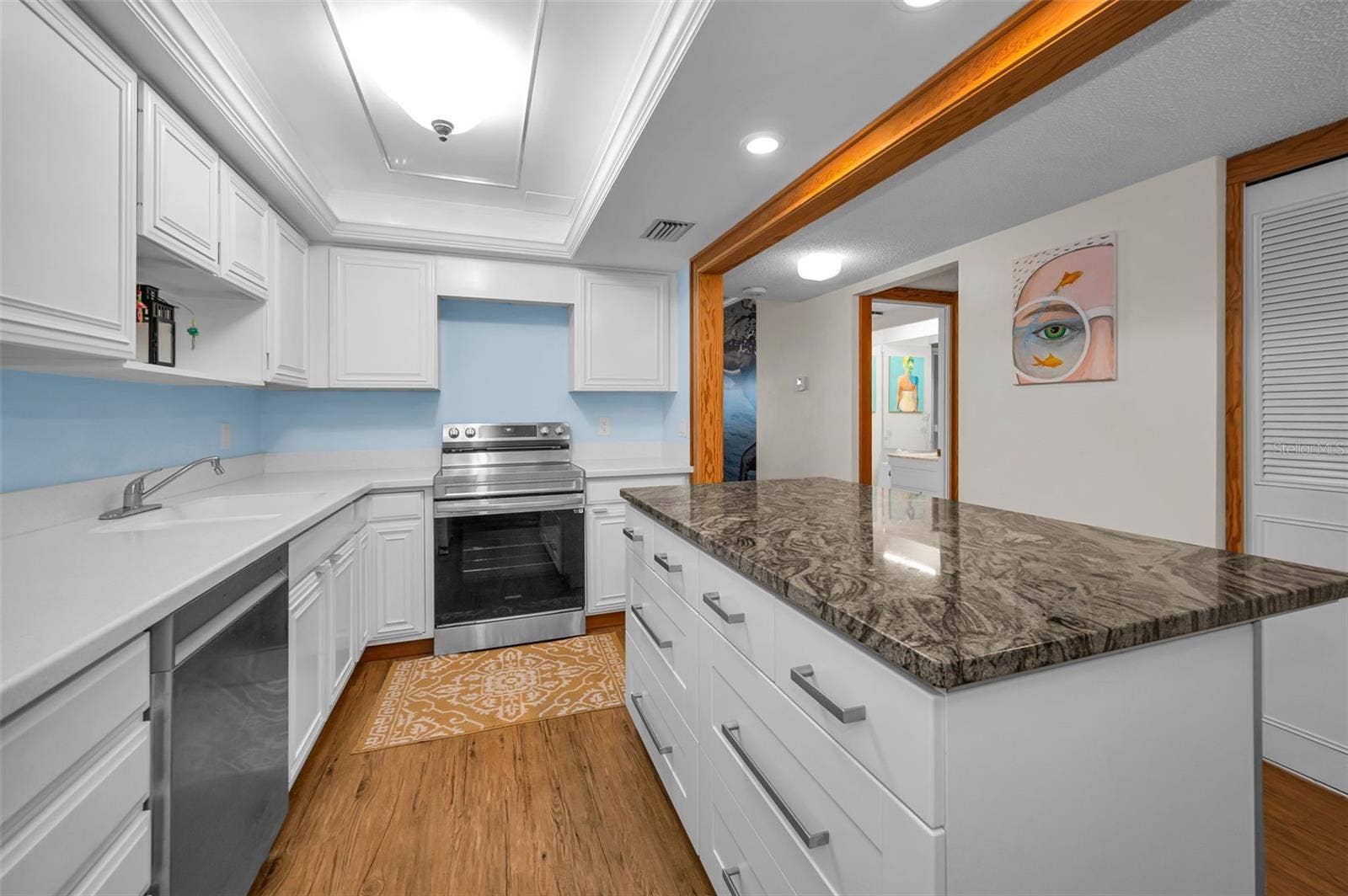 A bright coastal-modern kitchen featuring new appliances and an inviting center island