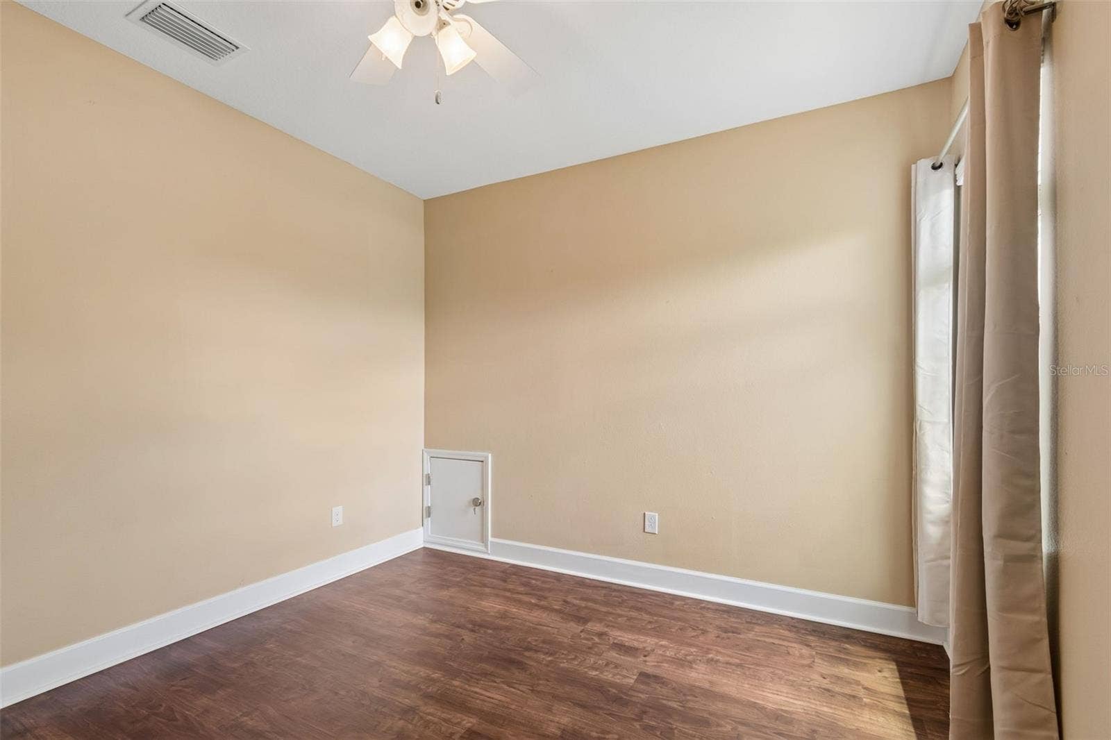 7090 88TH AVE N, Pinellas Park, FL 33782 Filled with natural light, this cheerful bedroom creates a warm and welcoming retreat.