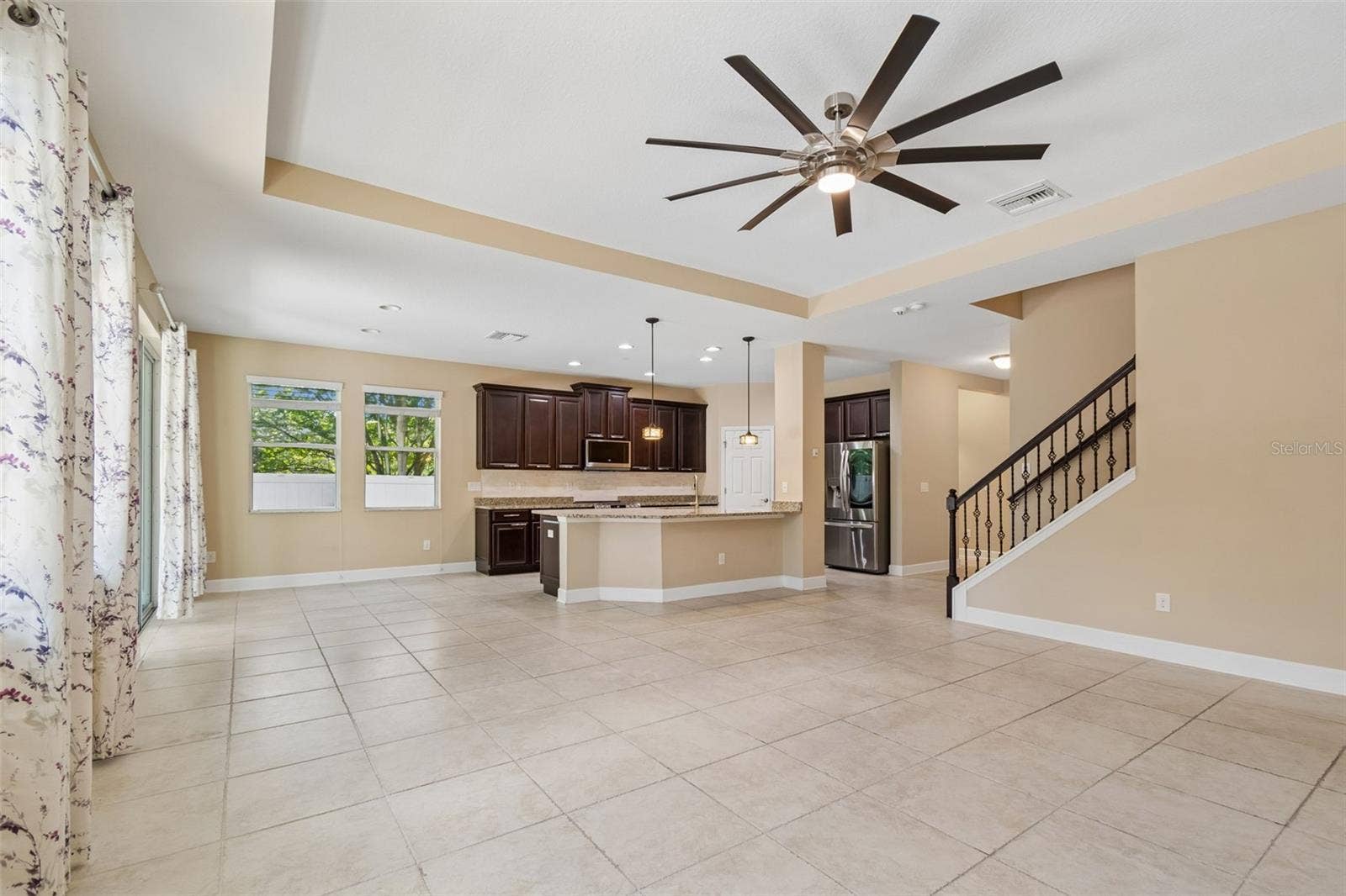 7090 88TH AVE N, Pinellas Park, FL 33782 The open-concept design connects the living room, dining area, and kitchen into one inviting gathering space.