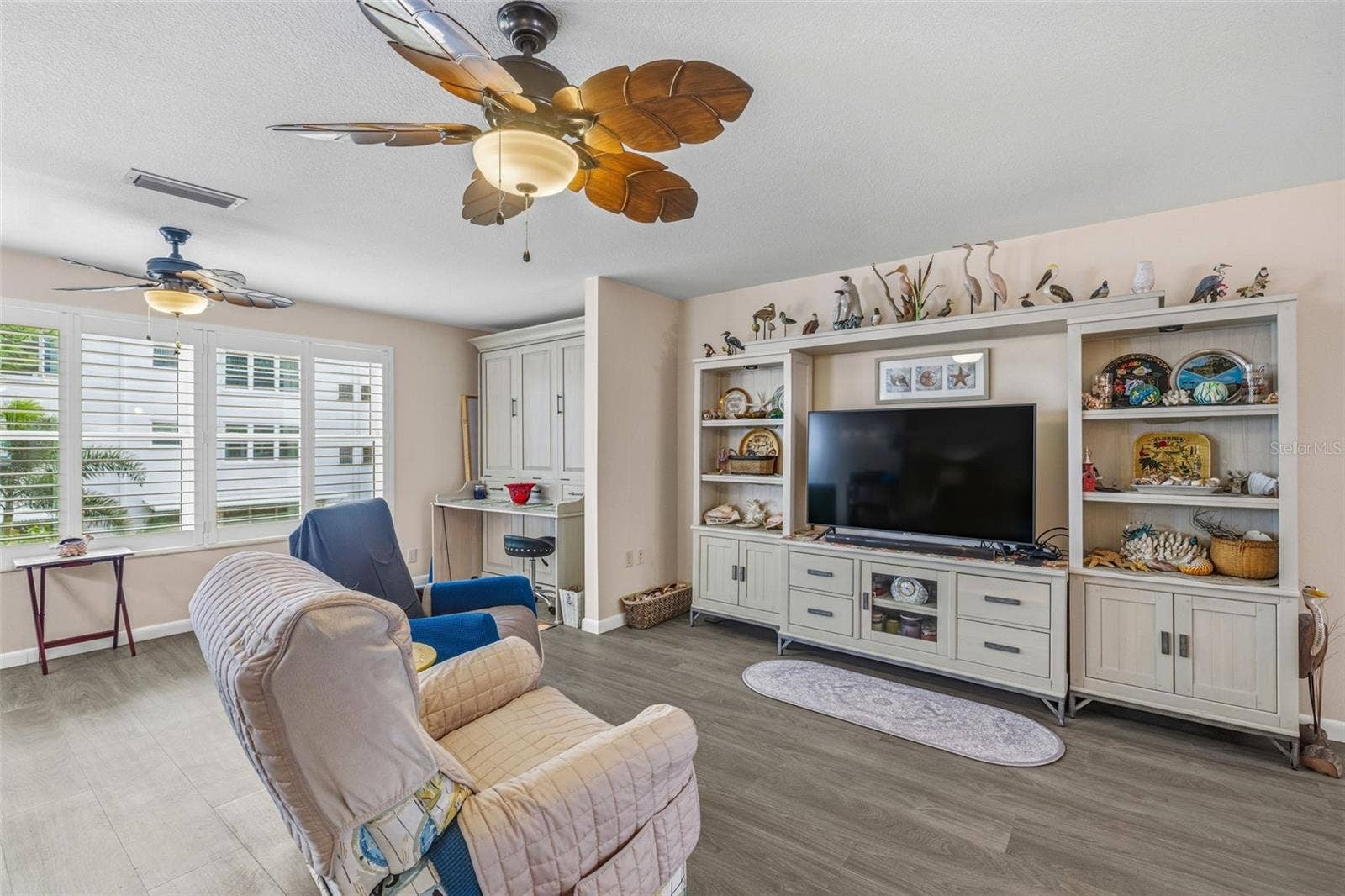 5521 80TH STREET N, #212, St Petersburg, FL 33709 Living room with built in storage and seating area