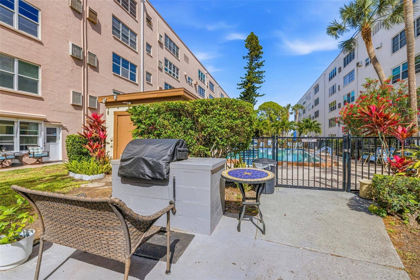 5521 80TH STREET N, #212, St Petersburg, FL 33709 Outdoor grill and patio by pool