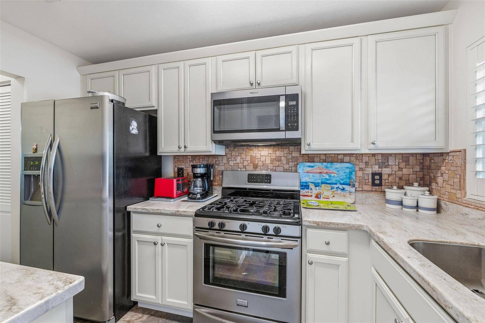 5521 80TH STREET N, #212, St Petersburg, FL 33709 Kitchen with stainless appliances and ample storage