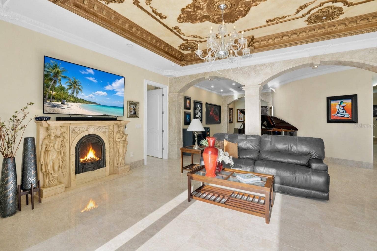 2000 PARK STREET N, St Petersburg, FL 33710 Ornate stone electric fireplace, intricate moldings on ceiling accented by chandeliers.