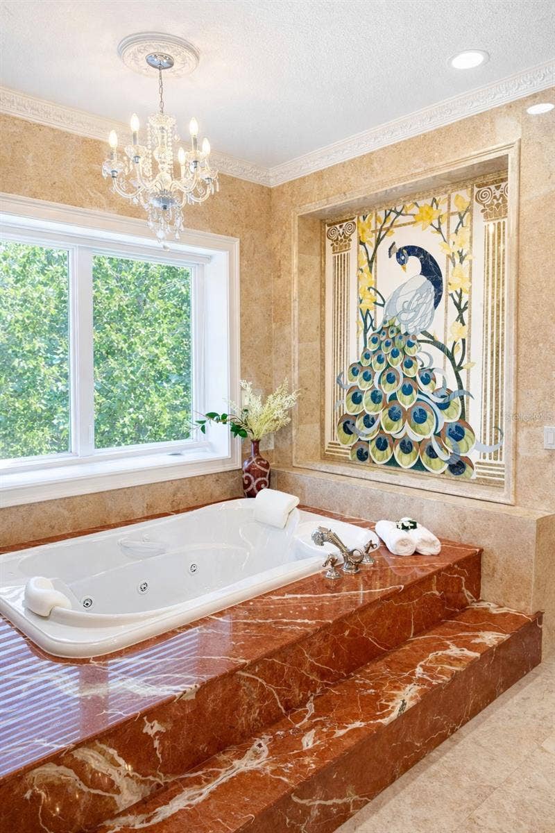 2000 PARK STREET N, St Petersburg, FL 33710 Phylrich dolphin fixtures, a Peacock inlaid in marble , a large sauna, soaking tub, multi-jet full-body rain shower, multiple vanities, and expansive custom closets