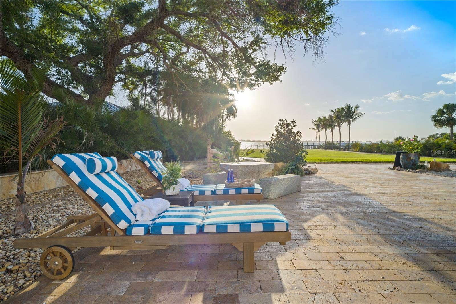2000 PARK STREET N, St Petersburg, FL 33710 Expansive poolside setting with multiple lounging areas across beautifully landscaped grounds.
