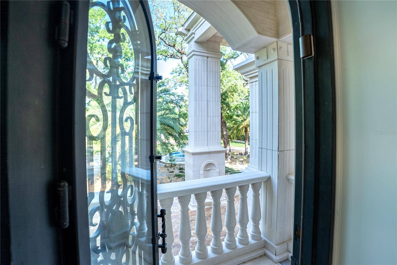 2000 PARK STREET N, St Petersburg, FL 33710 Arched black iron doors open to a private lanai off the spa-inspired marble bath with sauna, soaking tub, and custom detailing.