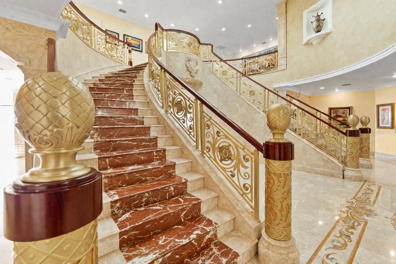 2000 PARK STREET N, St Petersburg, FL 33710 Sweeping dual marble inlaid staircases with gold and iron balustrades and ornate railings.