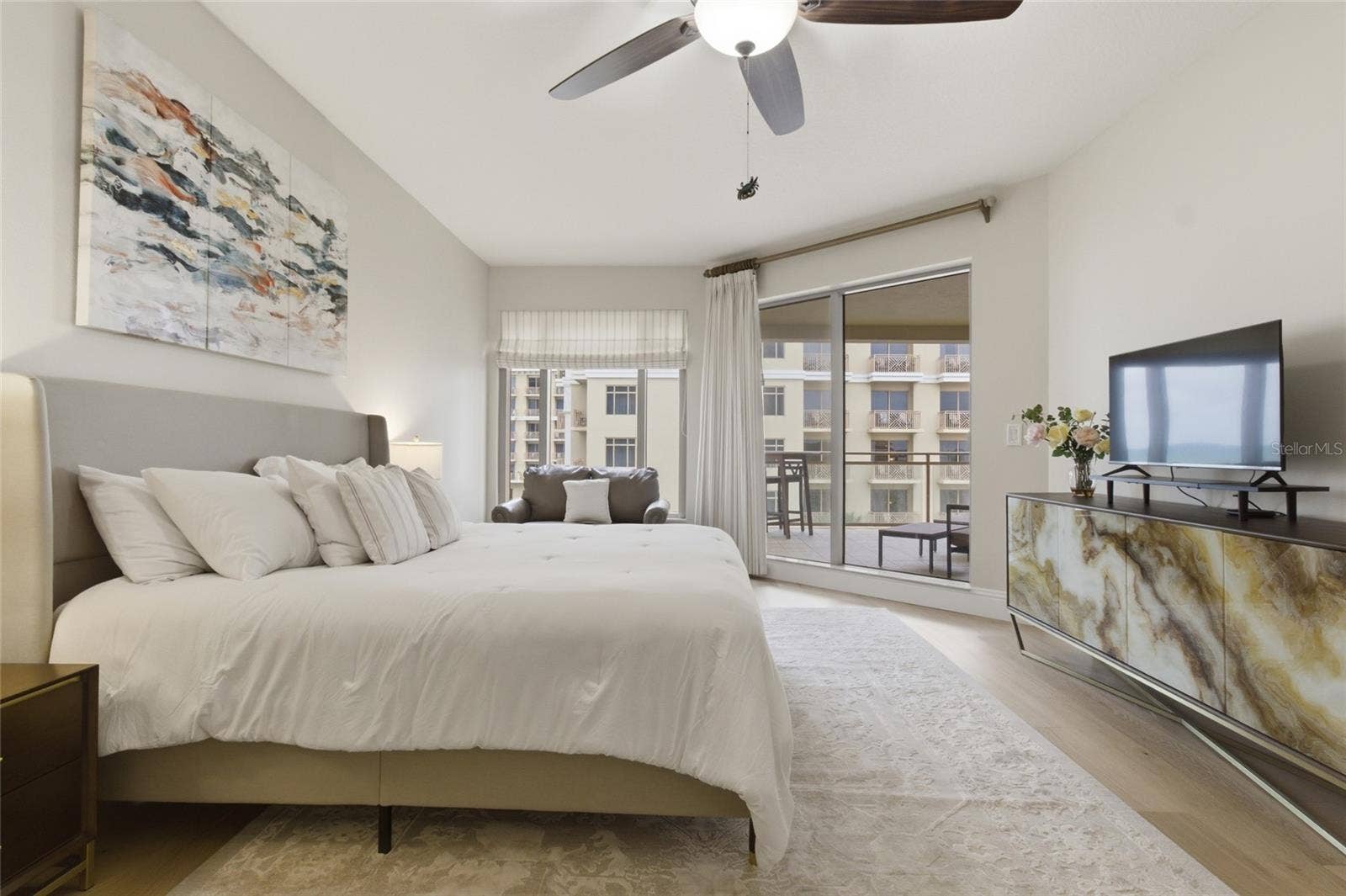Primary bedroom has sliders to private balcony.