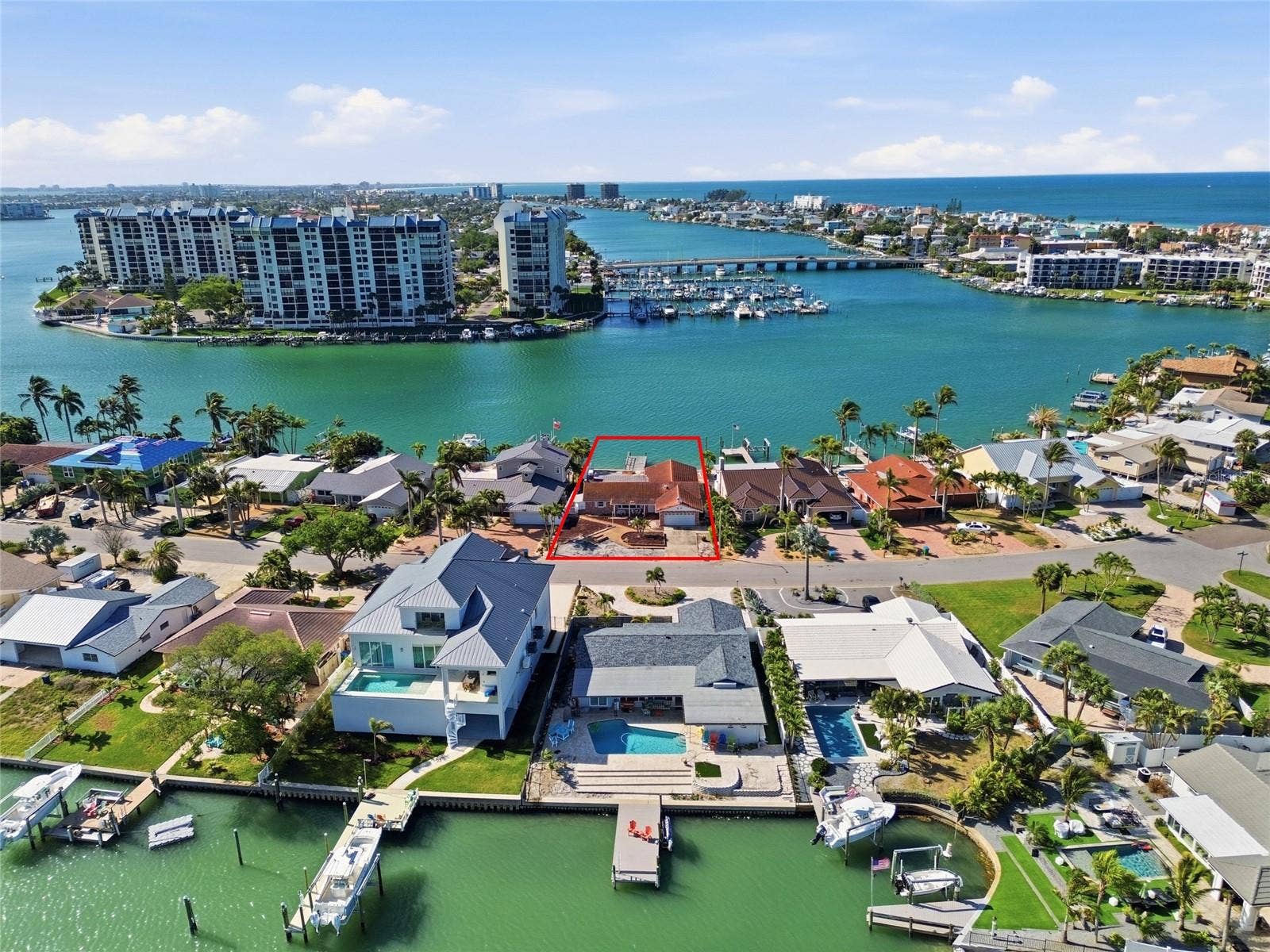 Drone shot looking down at 4 Bellevue and south to The Devil's Elbow and beyond the bridge leading to the beaches and the Gulf (the intracoastal contunues south on the left side).