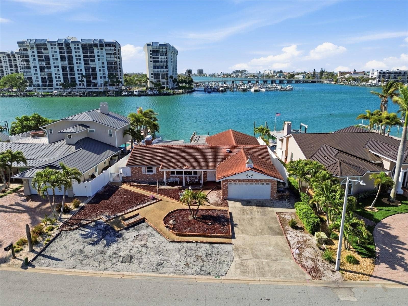 Drone shot of existing structure on 4 Bellevue Dr looking south at The Devil's Elbow on the Intracoastal and the one bridge to the Gulf in the foreground on the right.