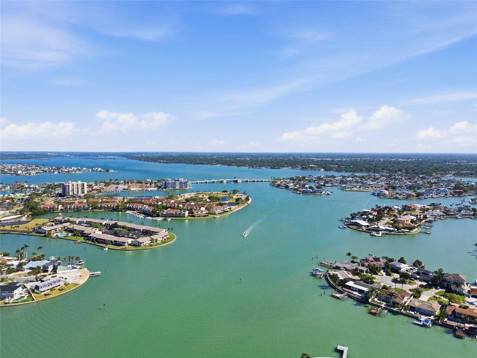 Aerial photo high above 4 Bellevue looking northwest towards Treasure Island Causeway drawbridge allowing access to the Gulf for larger sailboats and motorboats.