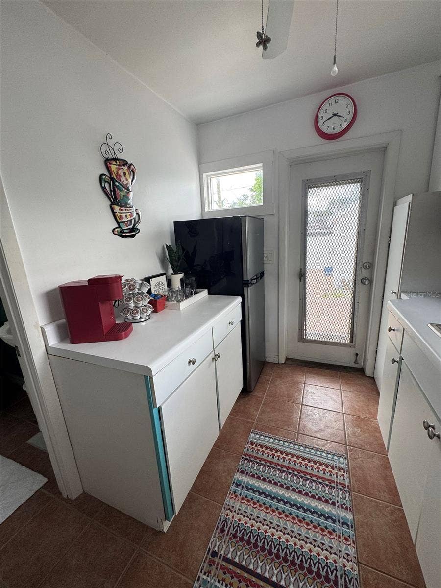 Back door leads to big fenced yard, studio and alley