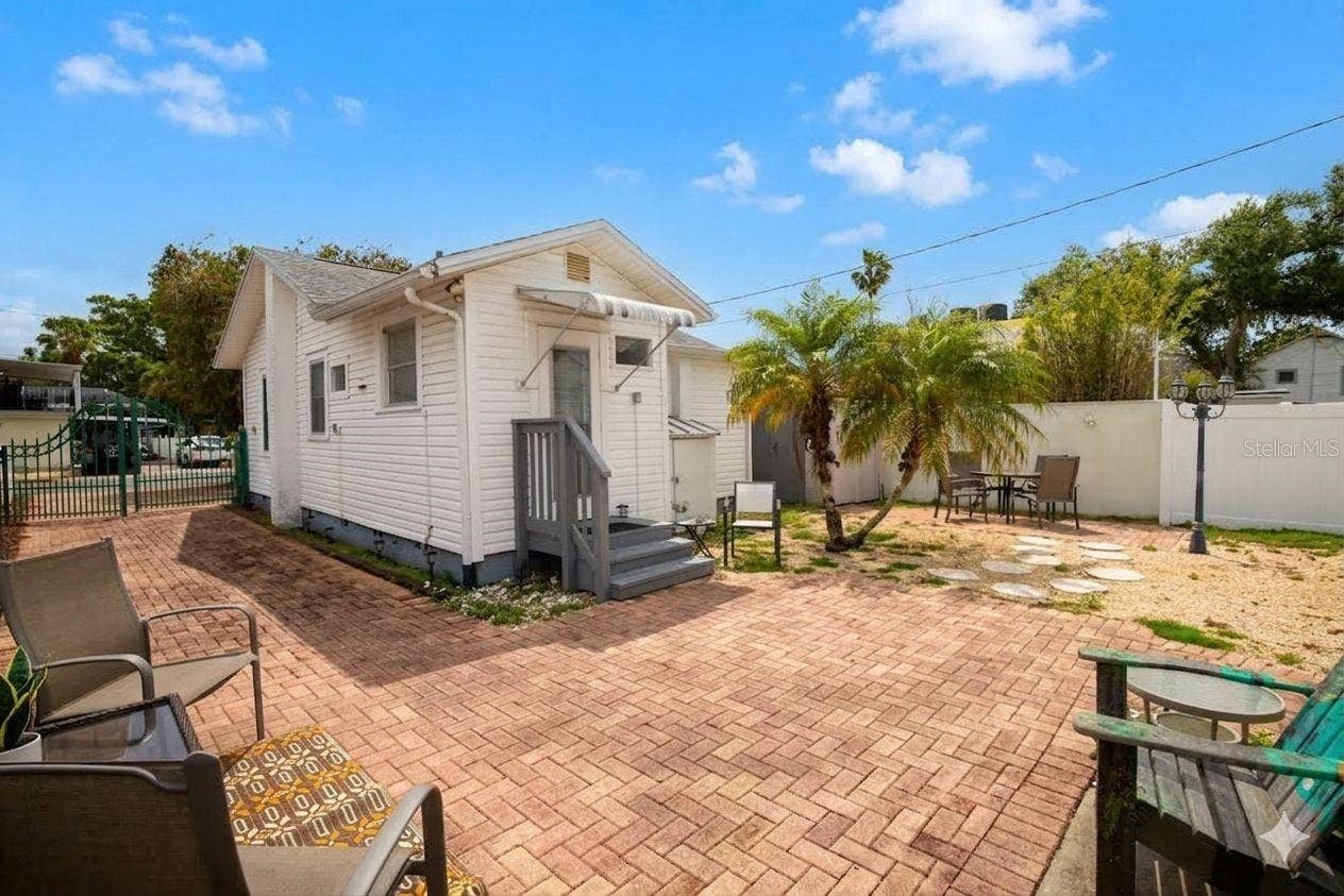Large brick patio area out back with a shed