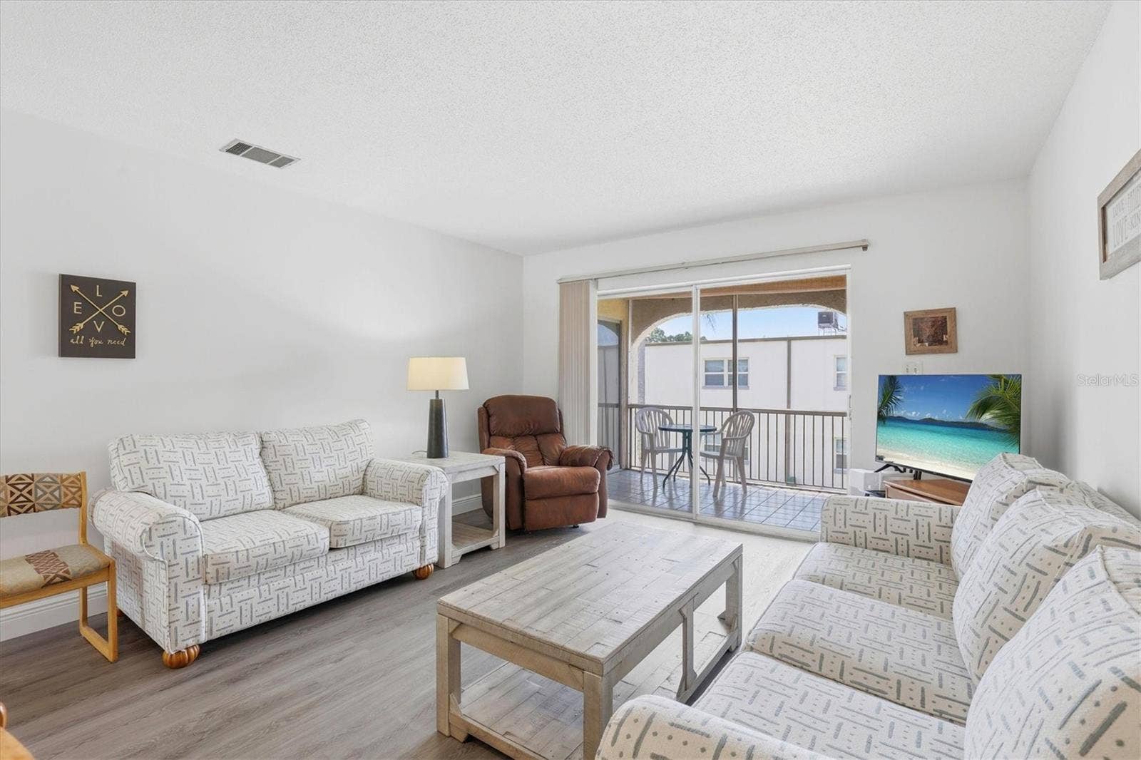 7701 STARKEY ROAD, #412, Seminole, FL 33777 Living room over looking Balcony