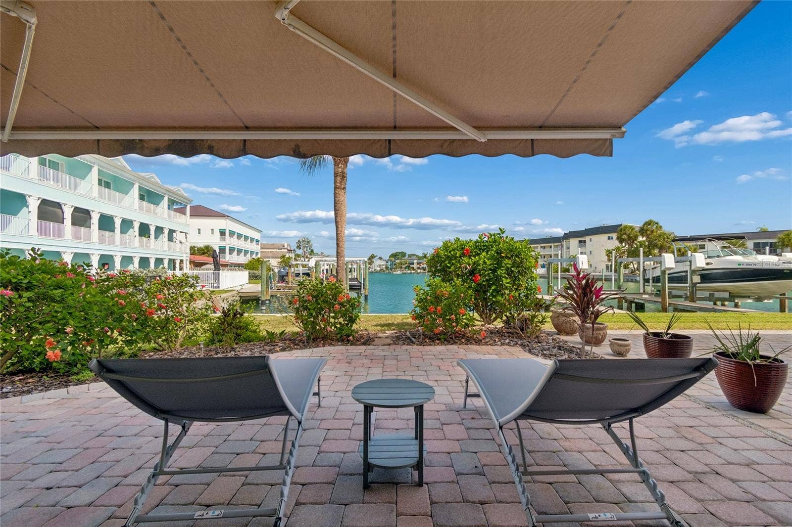 152 117TH AVENUE, Treasure Island, FL 33706 Downstairs you have your own patio right by the water where you can get creative with your plants and grill out