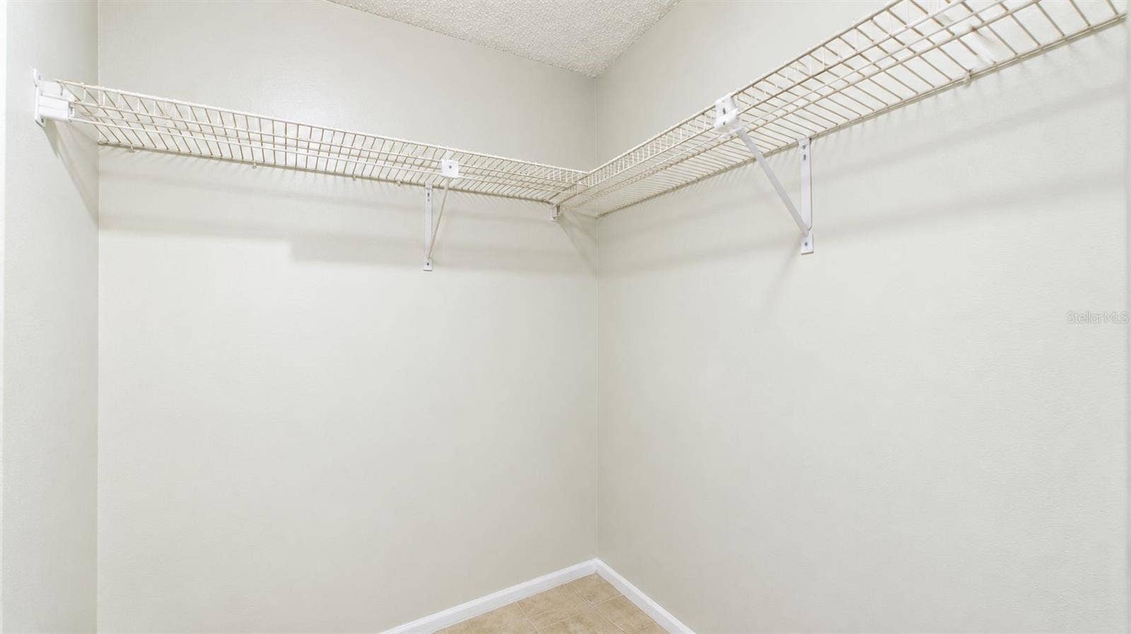 Primary bedroom walk-in closet
