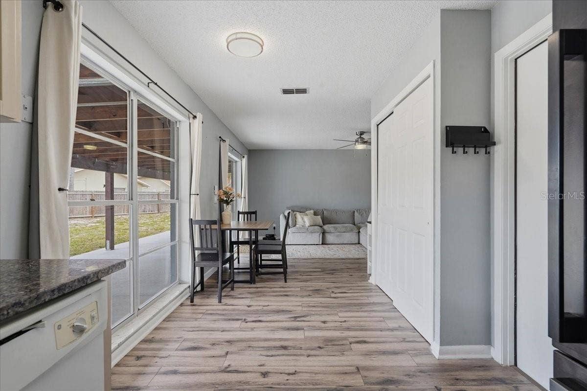 8913 WOOD LAKE COURT, New Port Richey, FL 34653 OPENS UP BEAUTIFULLY TO THE DINING AREA AND FAMILY ROOM!