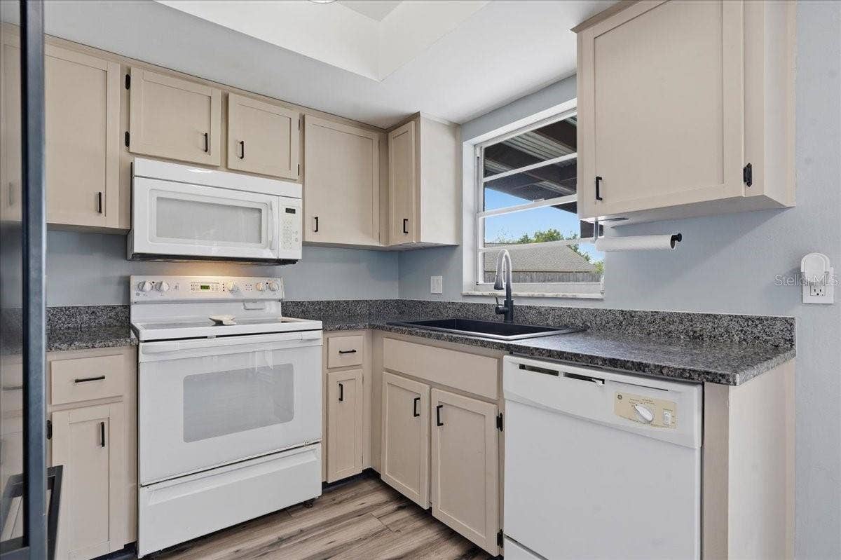 8913 WOOD LAKE COURT, New Port Richey, FL 34653 KITCHEN WITH PASS THRU WINDOW