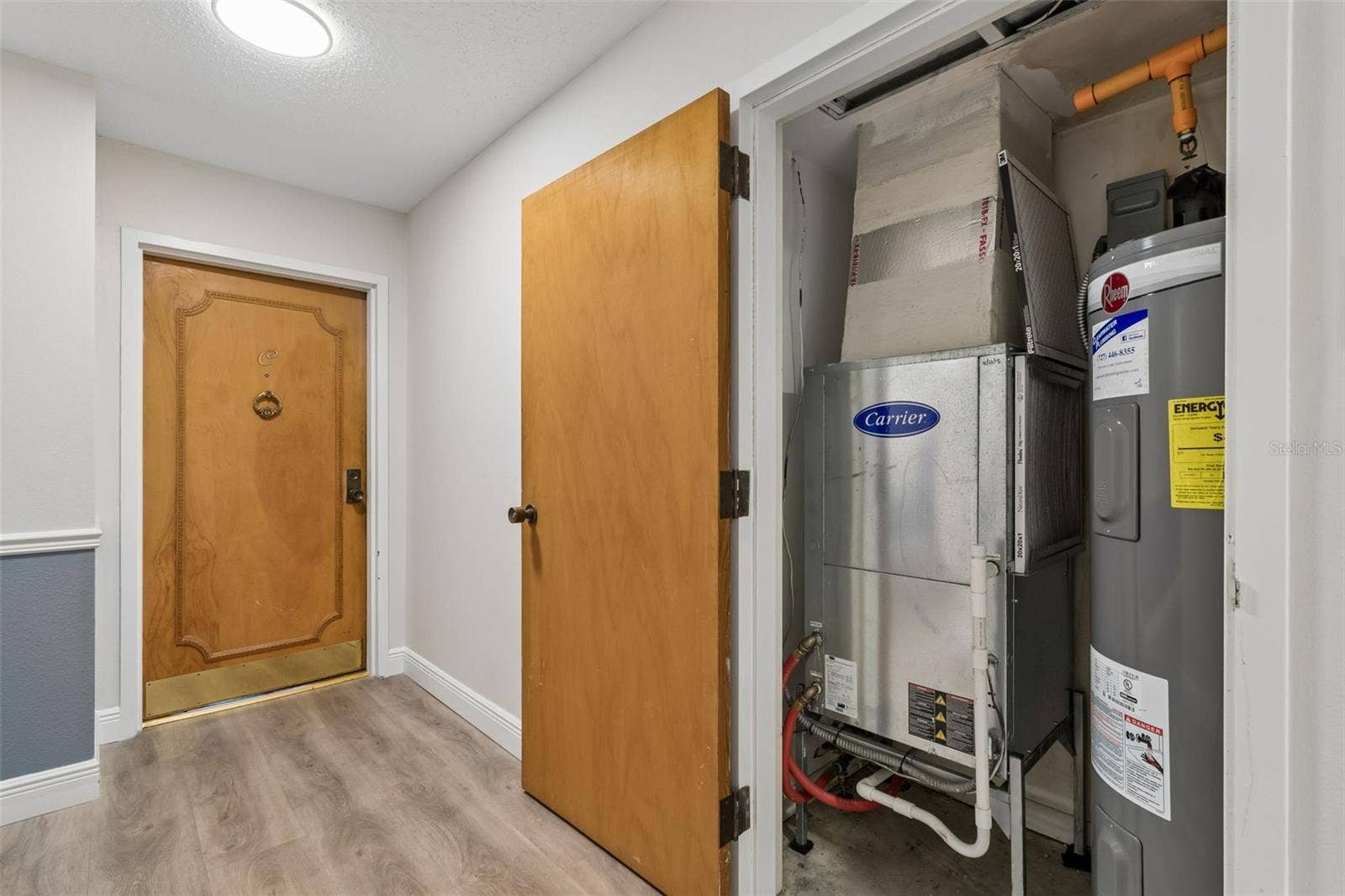 Utility closet for HVAC and water heater outside unit door