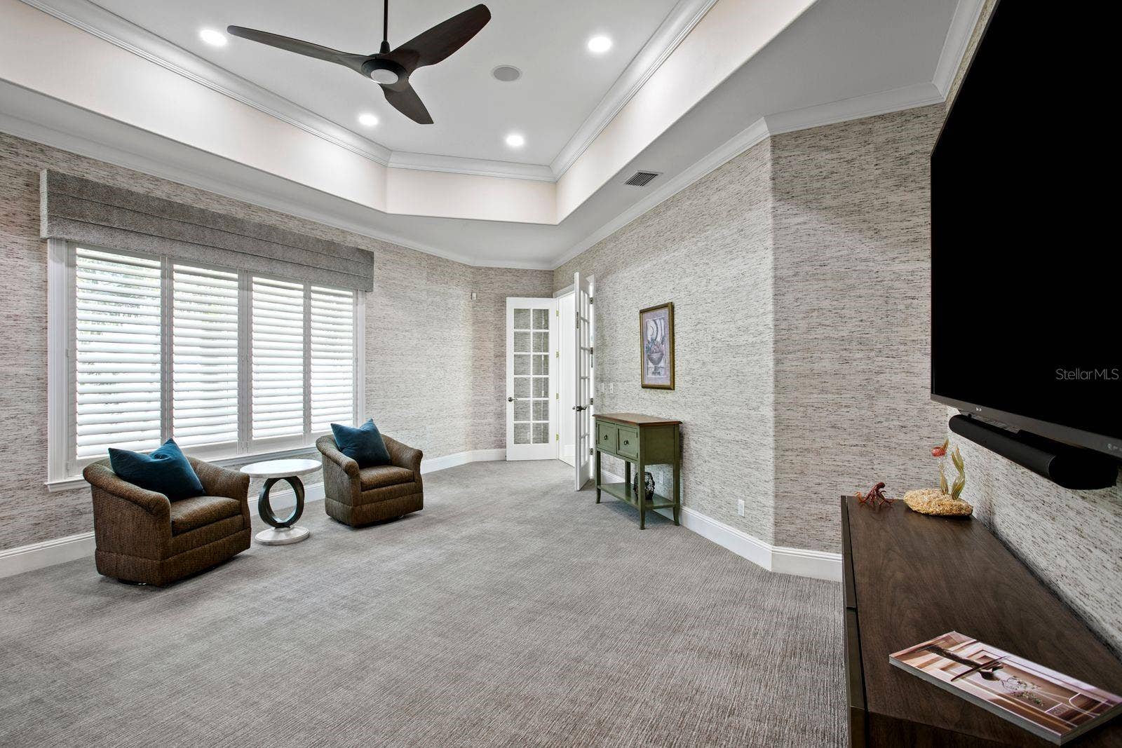 A sophisticated social lounge complete with a built in bar and media area.
