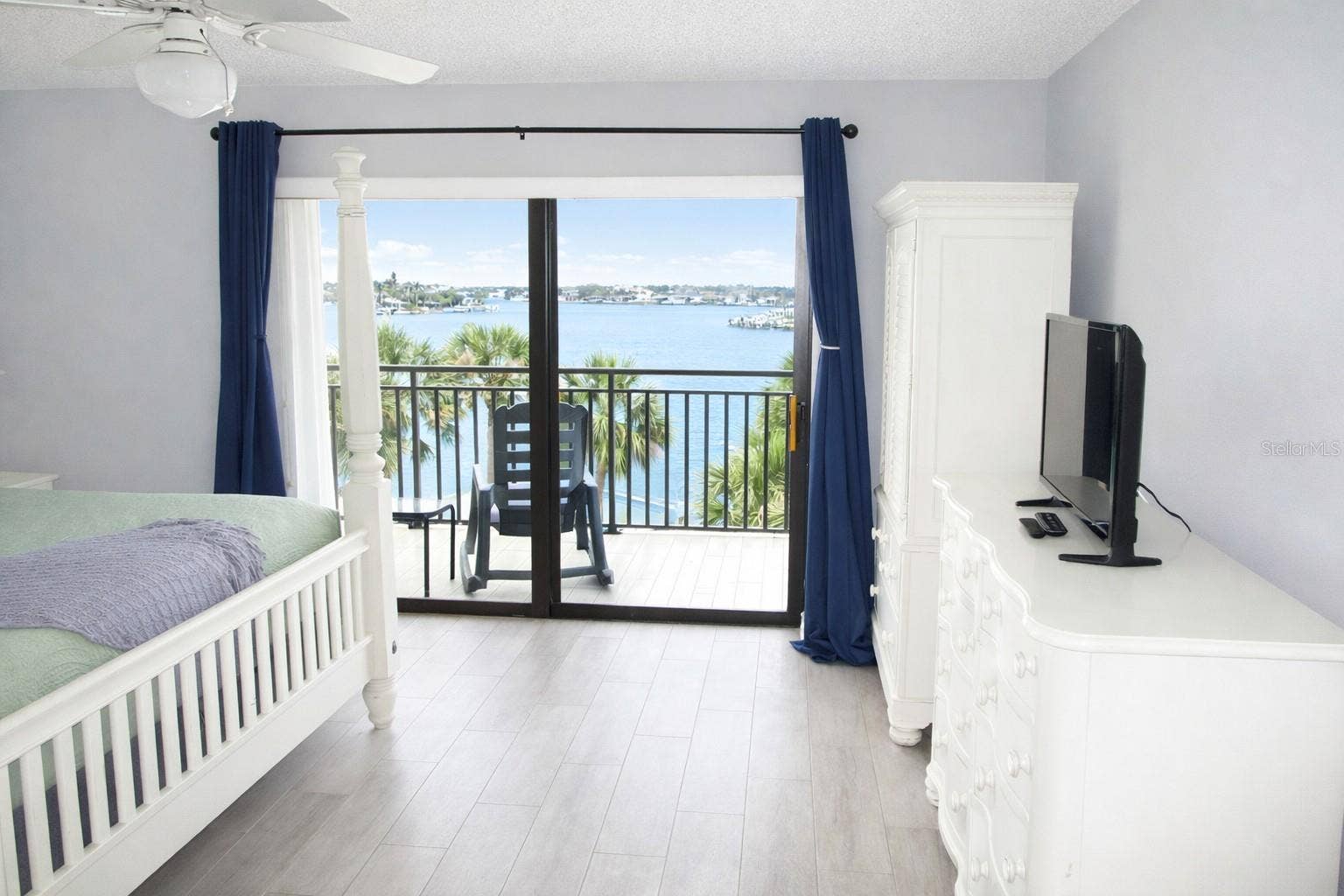 9825 HARRELL AVENUE, #404, Treasure Island, FL 33706 Primary Bedroom with entrance to balcony.