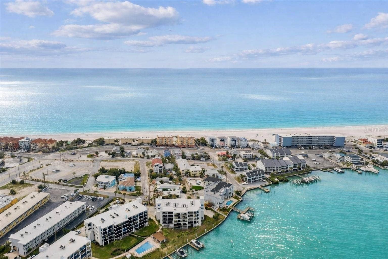 9825 HARRELL AVENUE, #404, Treasure Island, FL 33706 BEST LOCATION ON TREASURE ISLAND! Between the Gulf of Mexico and Blind Pass Waterway, Unit 404 offers the perfect blend of waterfront living and beachside convenience.