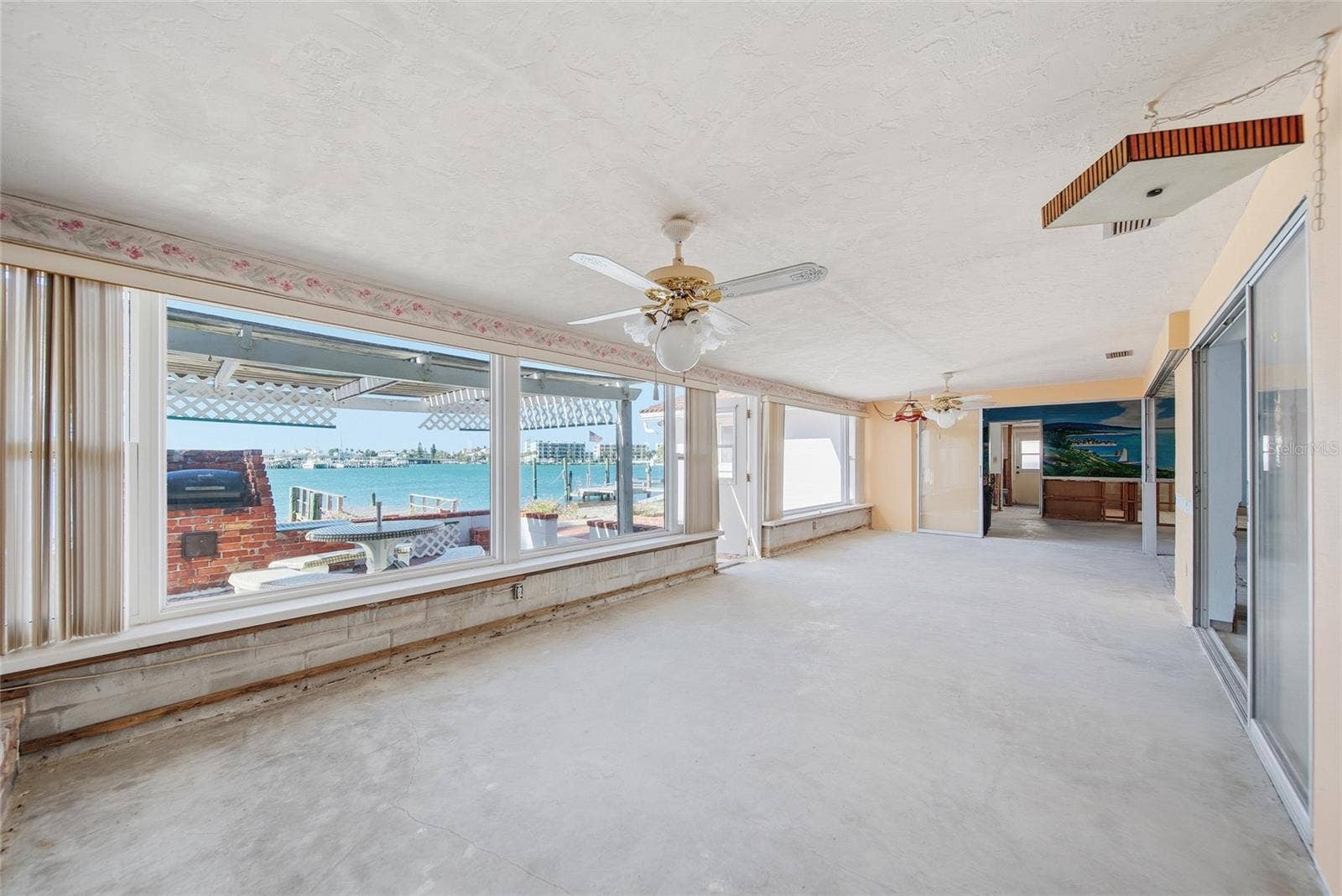 View from the family room looking south towards the turquoise waters of the Intracoastal. The existing kitchen area, living room, dining room, family room and second bedroom have Intracoastal water views.