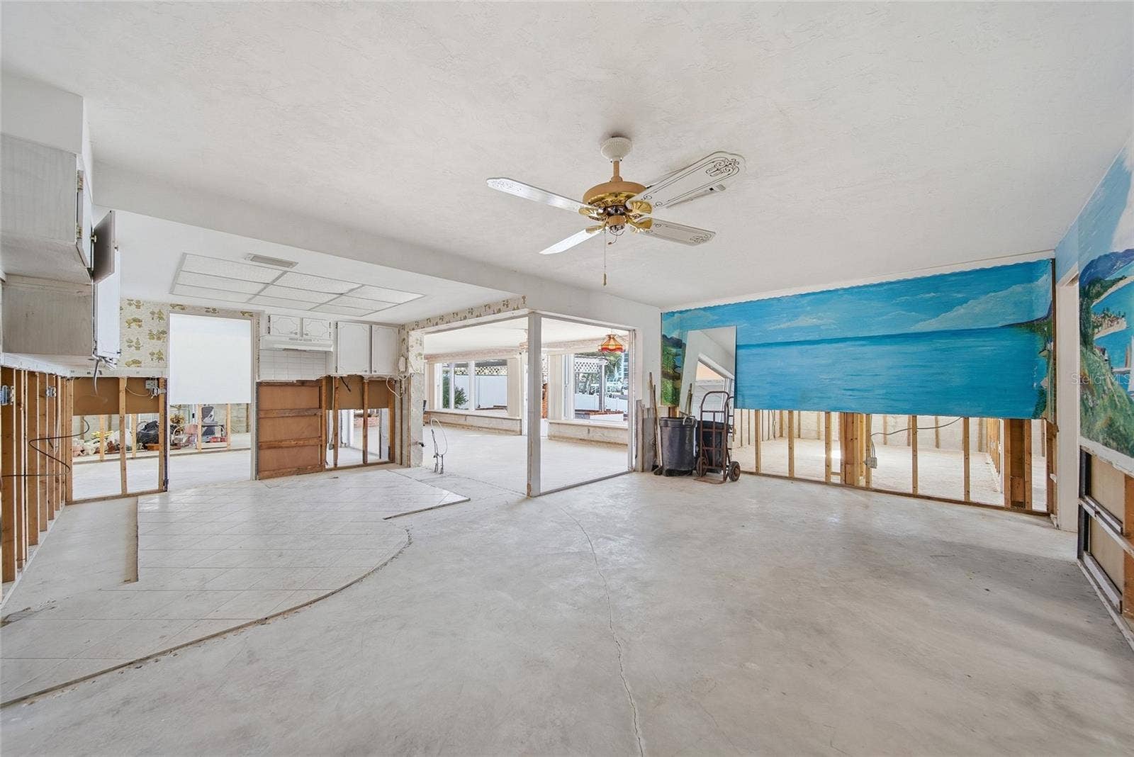 View from the back of the existing dining room looking southeast towards kitchen on the left and family room in the rear center.