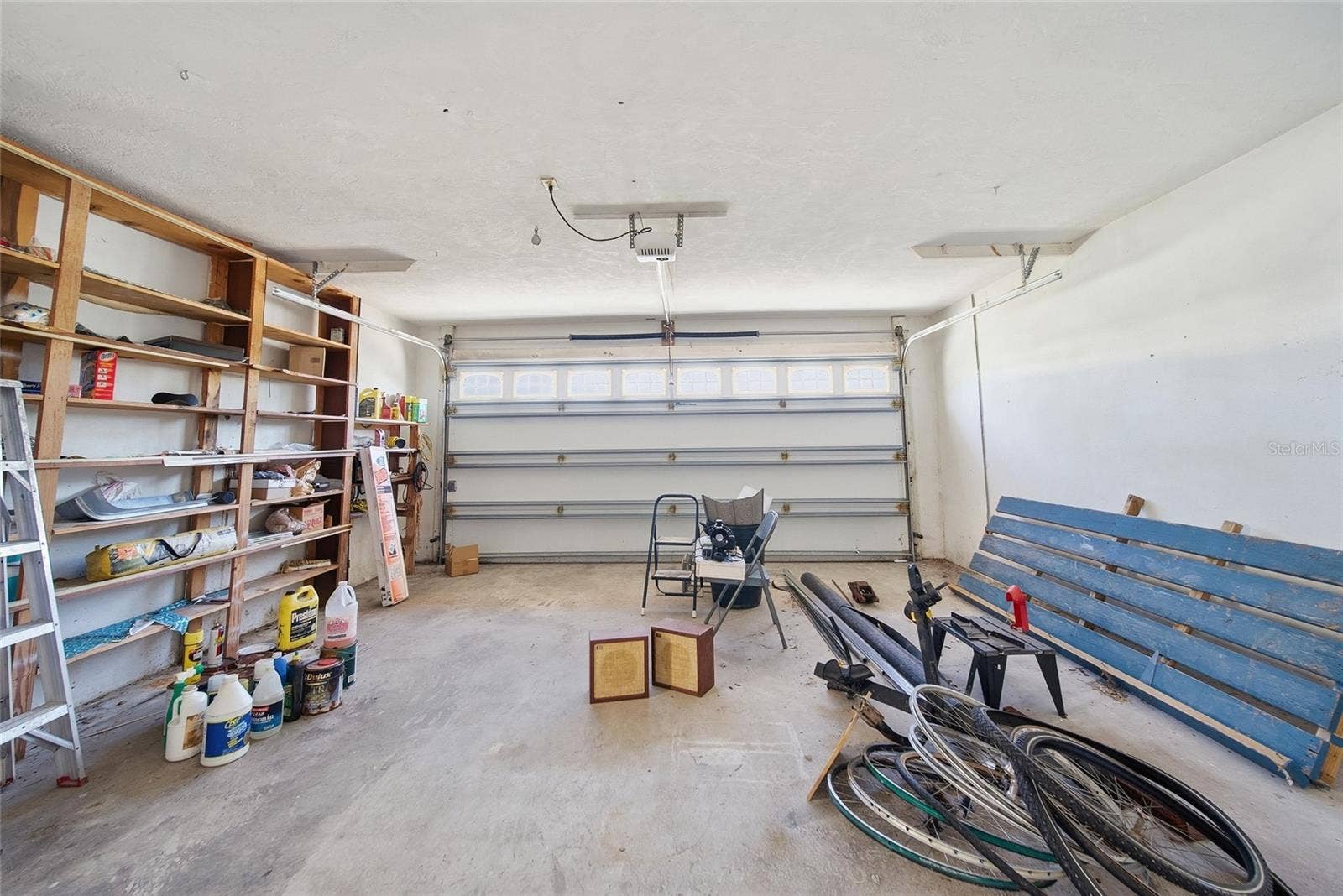 Double garage faces the street. The existing space behind the garage includes a separate work room and laundry room.