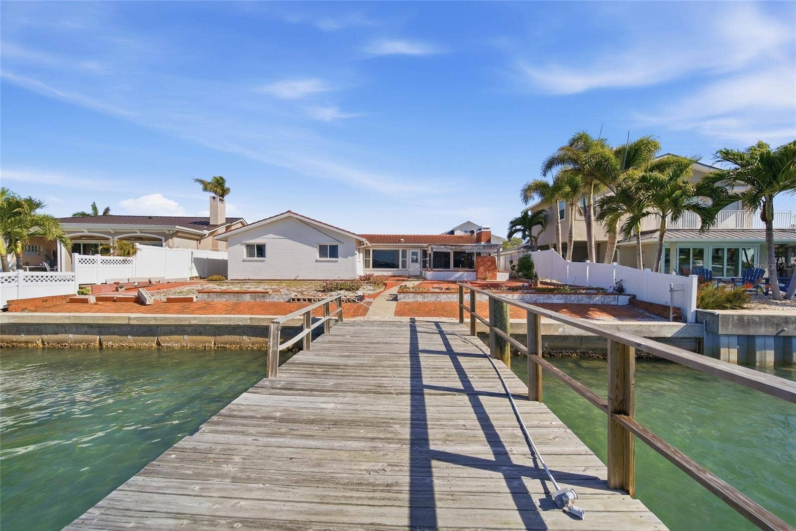 View from the end of the dock looking north towards the rear of the home (homes on either side are fully remediated).