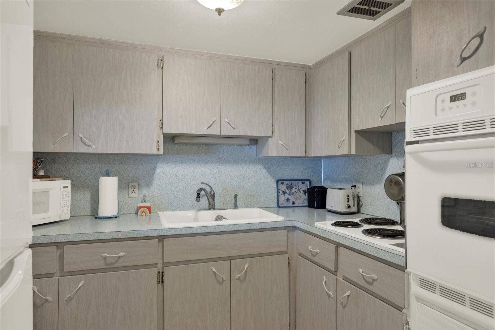 Kitchen-Ample-Cabinetry-Double-Sink-White-Appliances-Clearwater-FL