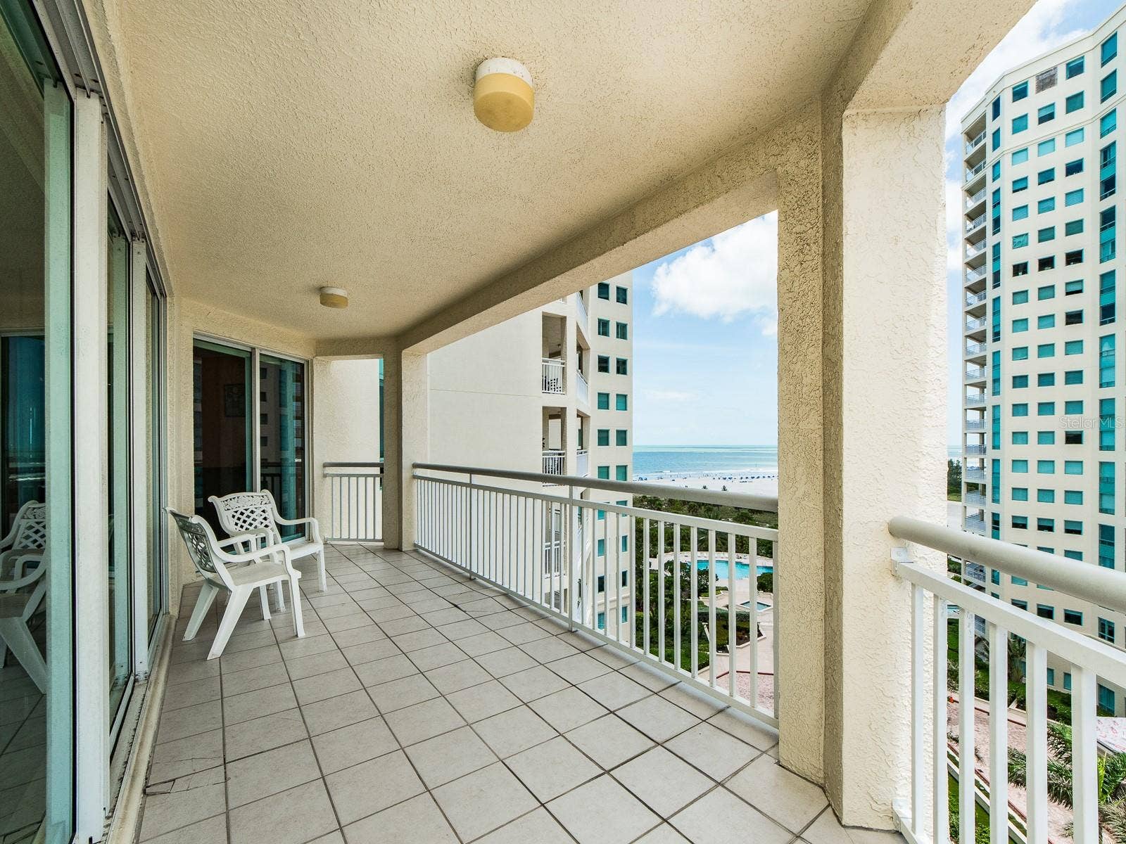 1180 GULF BOULEVARD, #906, Clearwater Beach, FL 33767 Large balcony spreading from living area, kitchen, and den.