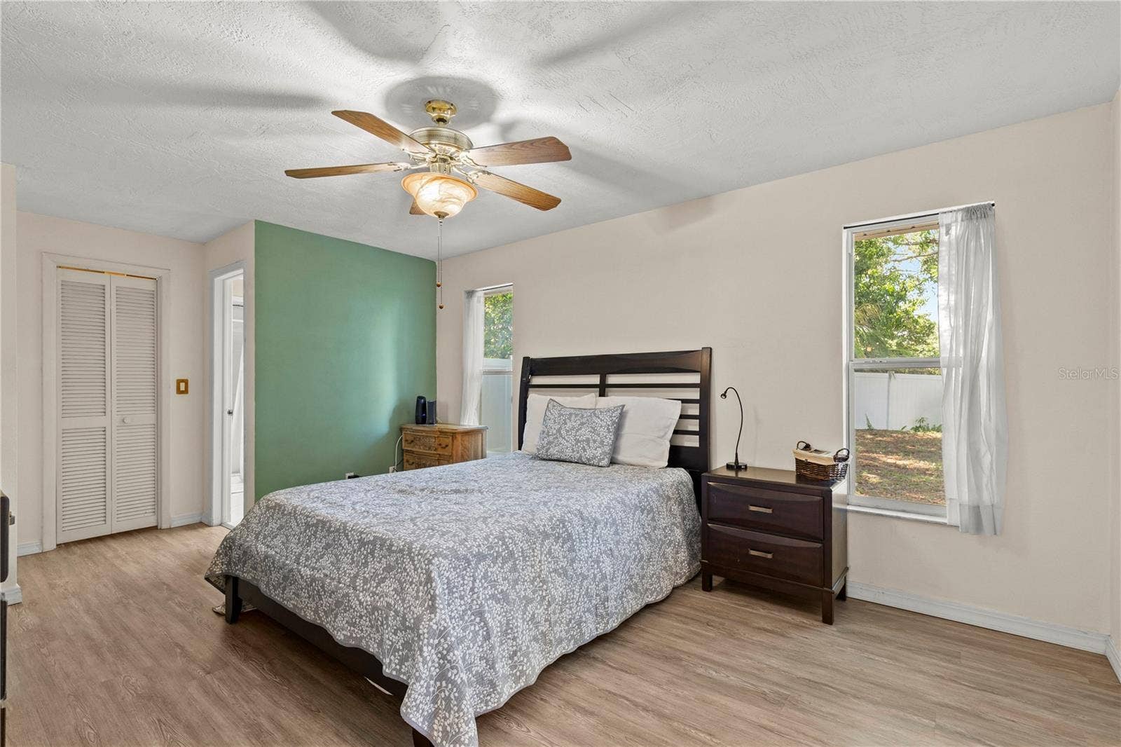 Spacious primary bedroom retreat featuring a bright and airy layout, offering a comfortable and private space to unwind. The room provides ample natural light and a peaceful atmosphere, creating the perfect owners suite for rest and relaxation