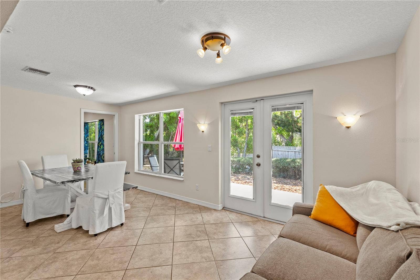 Versatile Florida room filled with natural light, offering the perfect space for a dining area, sitting room, home office, or additional living space. Large windows create a bright and airy atmosphere while providing beautiful views of the outdoors