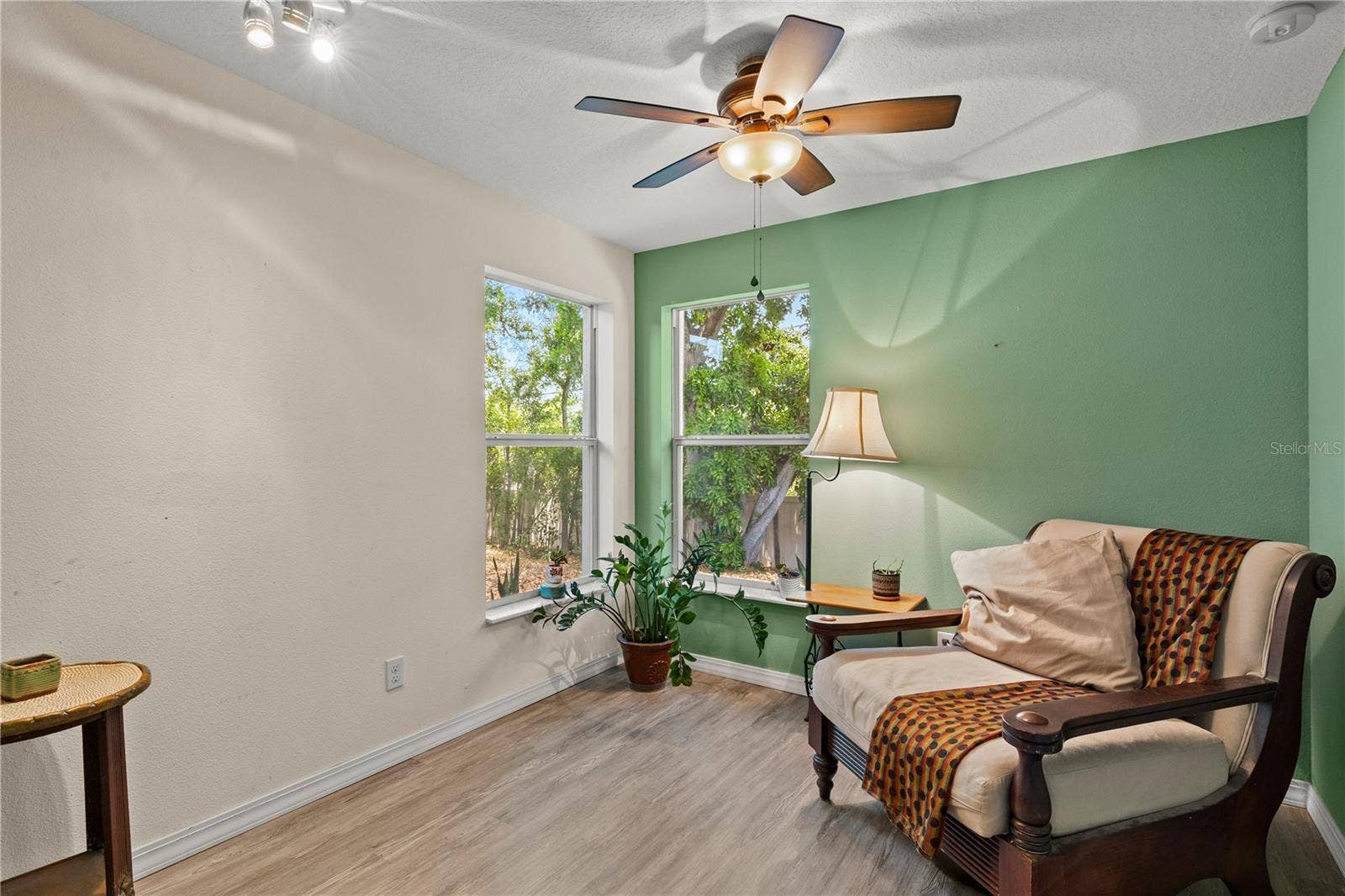 Spacious primary bedroom retreat featuring a bright and airy layout with a comfortable sitting area, creating the perfect space for relaxation and privacy. The room offers abundant natural light and a peaceful atmosphere, ideal for an owners suite designed for comfort and everyday living.