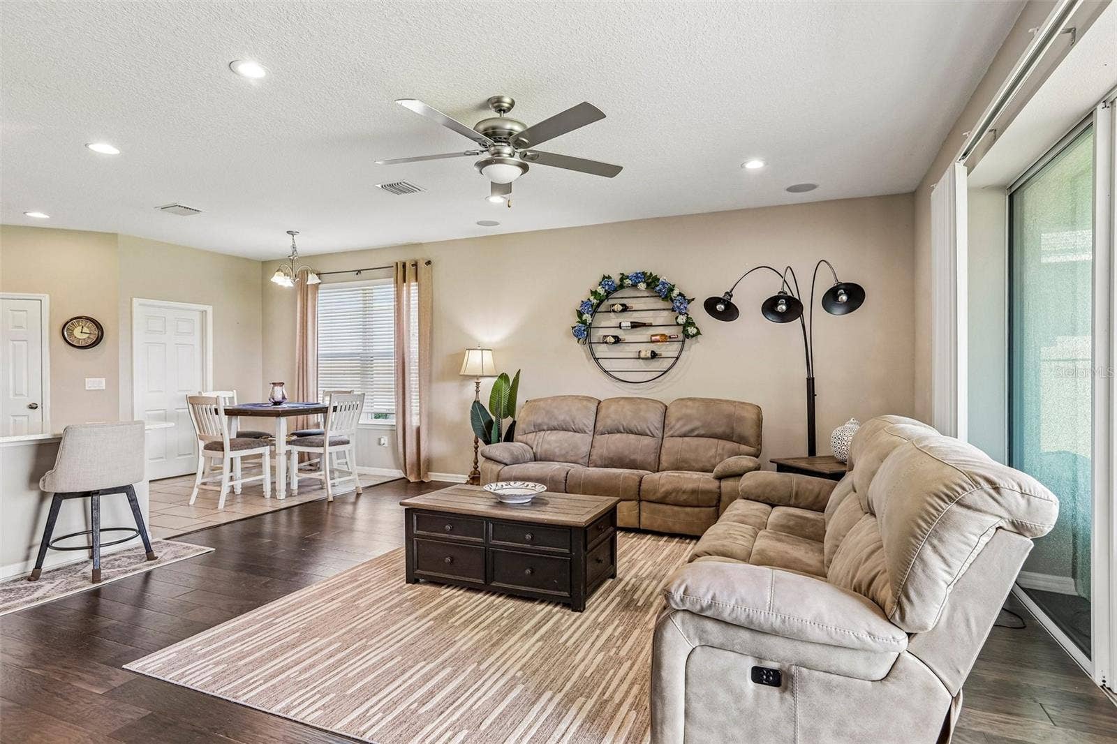17628 BRIGHT WHEAT DRIVE, Lithia, FL 33547 Family Room with beautiful hard wood floors, neutral colors and view to dinette area and kitchen.