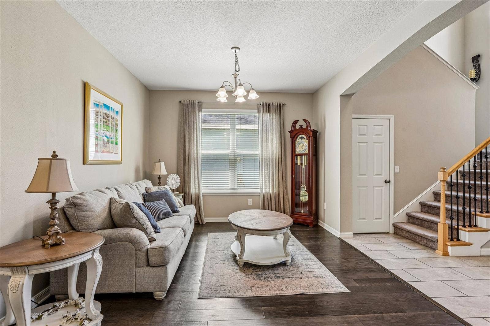17628 BRIGHT WHEAT DRIVE, Lithia, FL 33547 Inviting Living Room with hard wood floors and neutral colors. View to the front door and stairs to 2nd floor