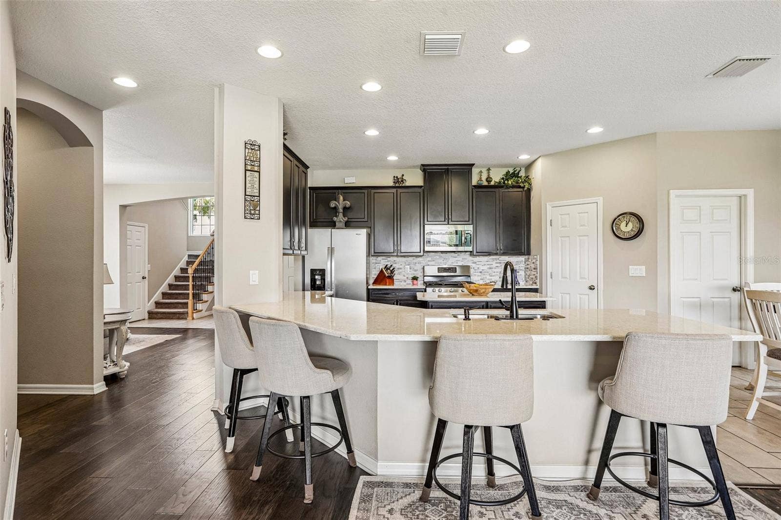 17628 BRIGHT WHEAT DRIVE, Lithia, FL 33547 Kitchen area with 42" cabinets, stained appliances, gas range, beautiful backsplash, Island and quartz