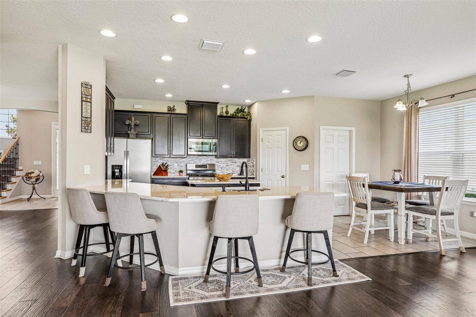 17628 BRIGHT WHEAT DRIVE, Lithia, FL 33547 Kitchen area with 42" cabinets, stained appliances, gas range, beautiful backsplash, Island and quartz