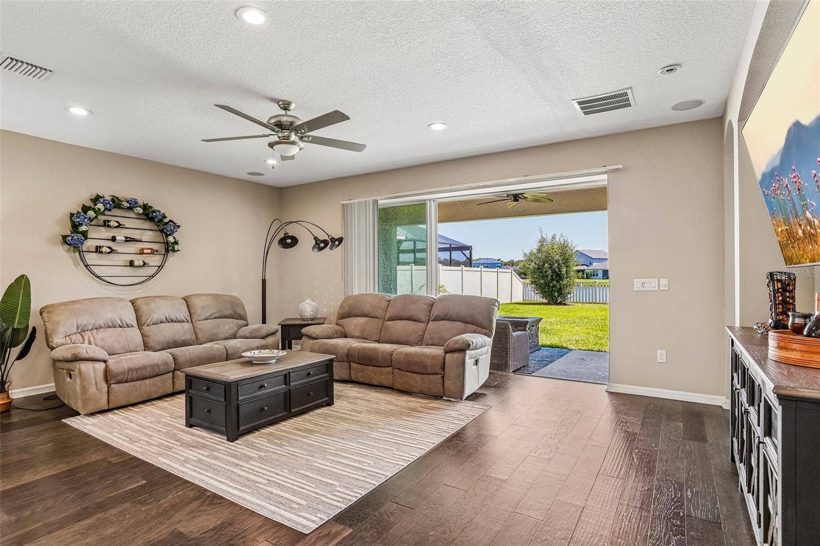 17628 BRIGHT WHEAT DRIVE, Lithia, FL 33547 Family Room with beautiful hard wood floors, neutral colors, sliders to the back yard and open to the kitchen