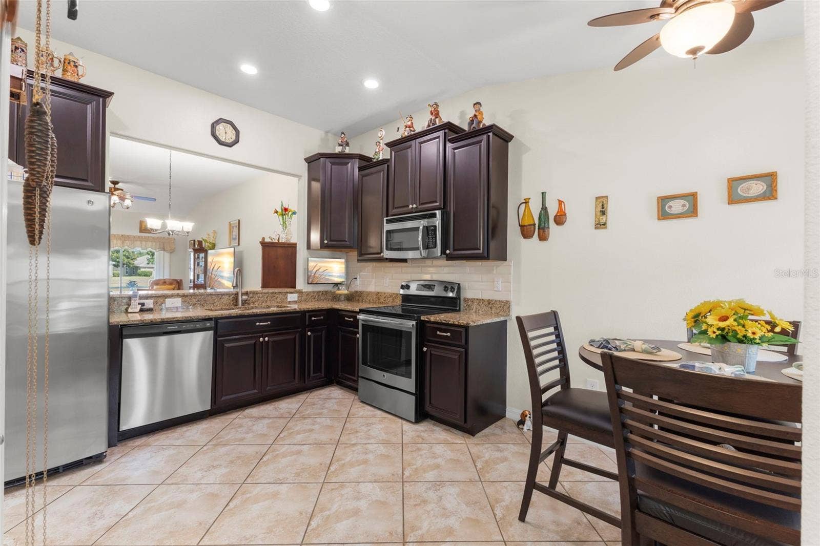 13627 CREST LAKE DRIVE, Hudson, FL 34669 Kitchen with dark wood cabinetry, Stainless Steel appliances and granite counters