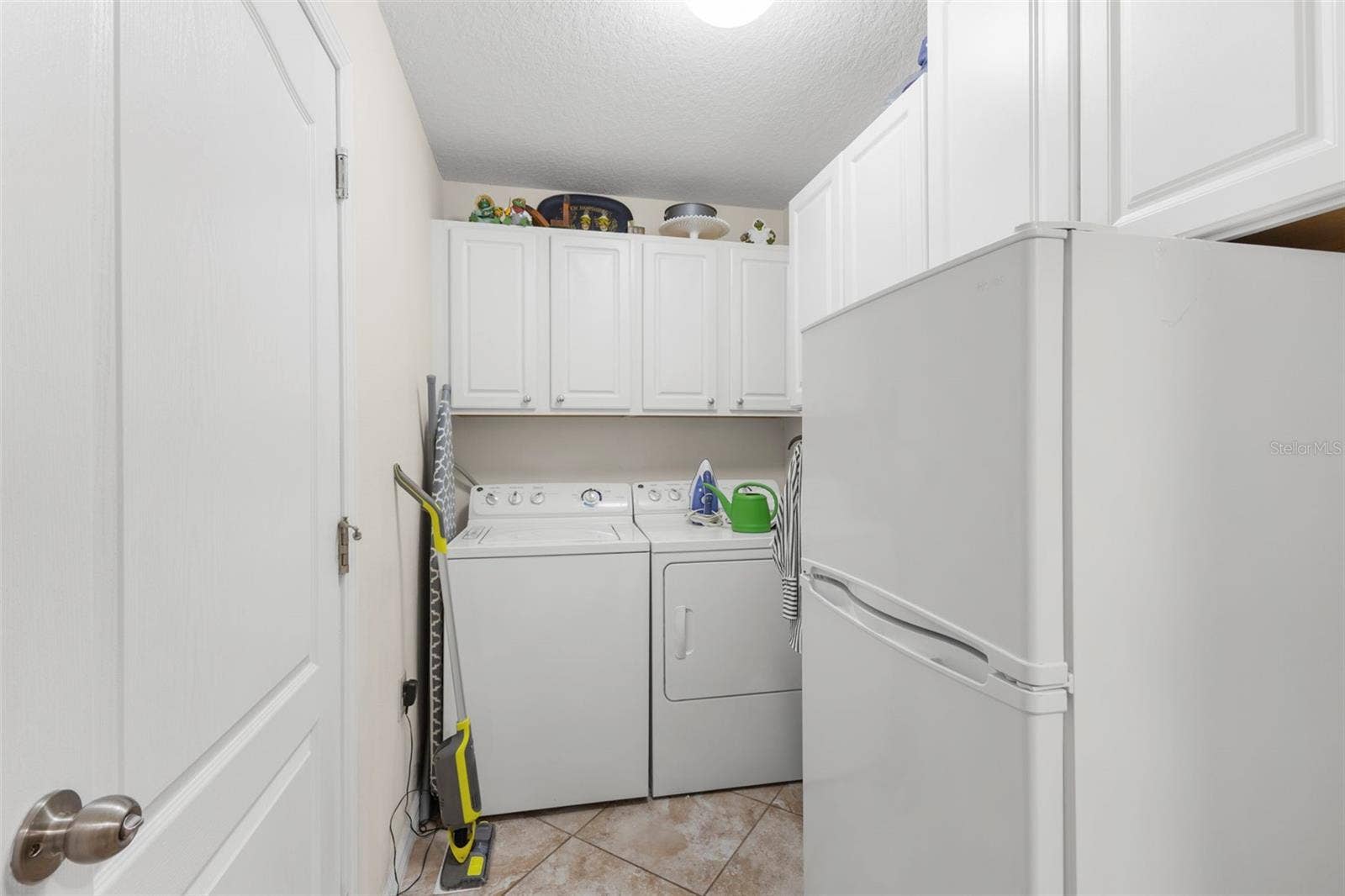 13627 CREST LAKE DRIVE, Hudson, FL 34669 Laundry room with bonus refrigerator/freezer and cabinets for storage