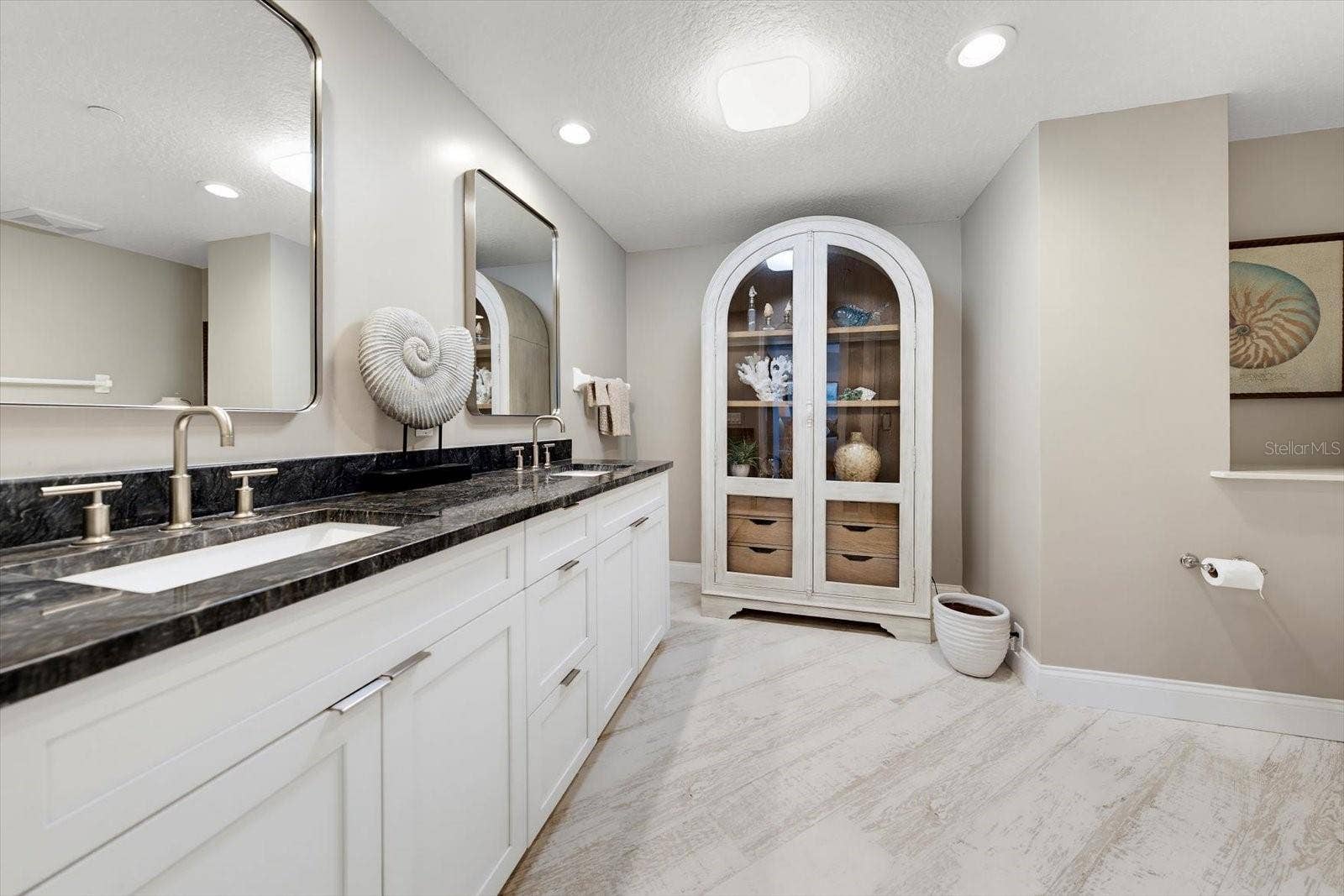1170 GULF BOULEVARD, #404, Clearwater Beach, FL 33767 En-suite bathroom with high counter dual vanity & custom cabinet for additional storage.