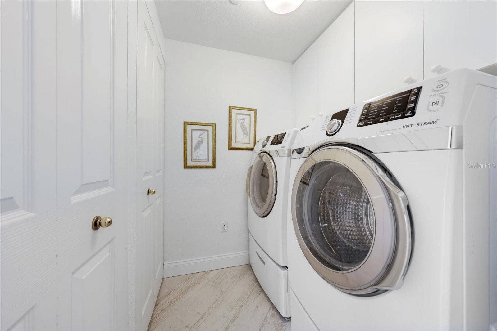 1170 GULF BOULEVARD, #404, Clearwater Beach, FL 33767 Laundry room offering oversized washer & dryer.