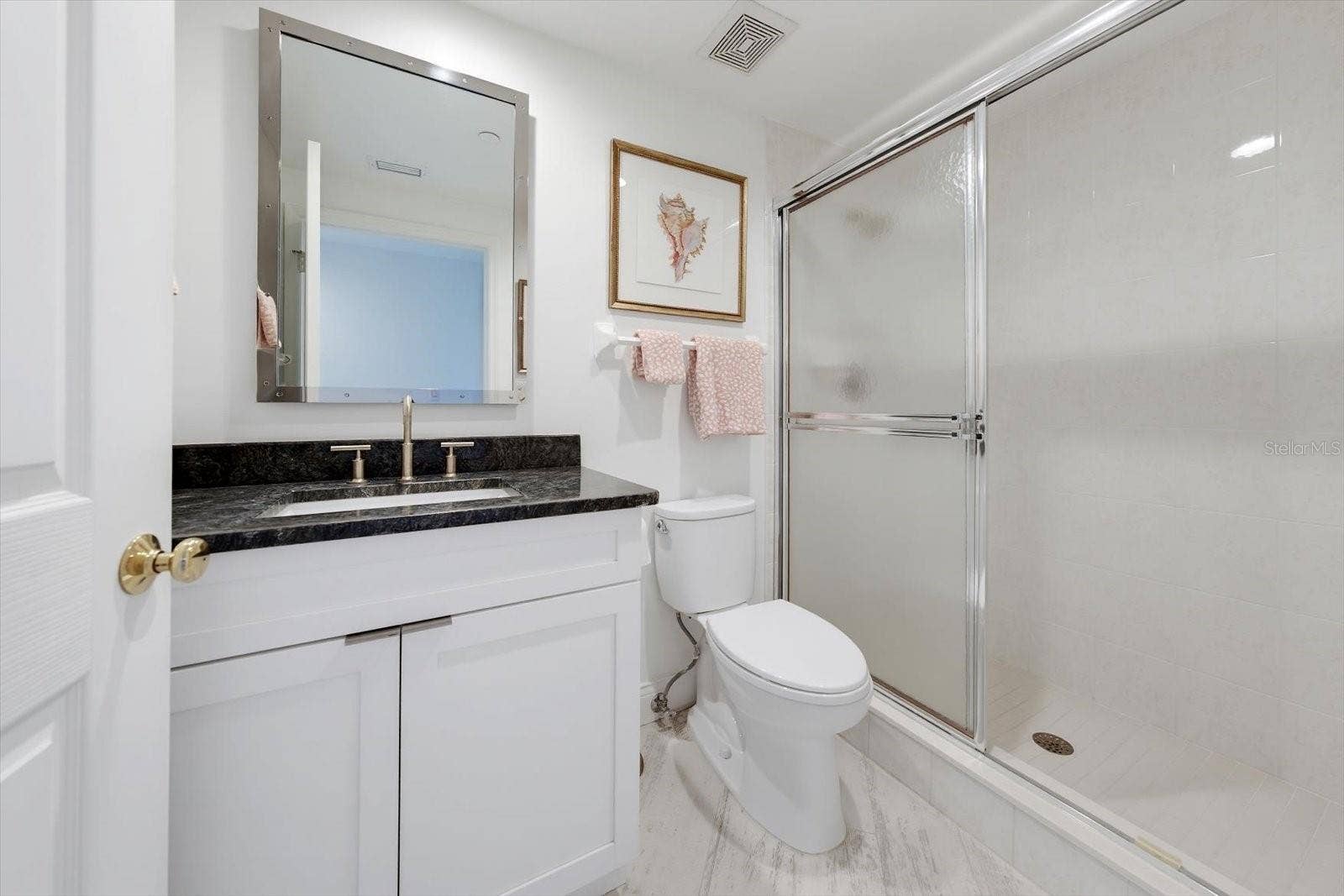 1170 GULF BOULEVARD, #404, Clearwater Beach, FL 33767 Guest bathroom with beautiful vanity