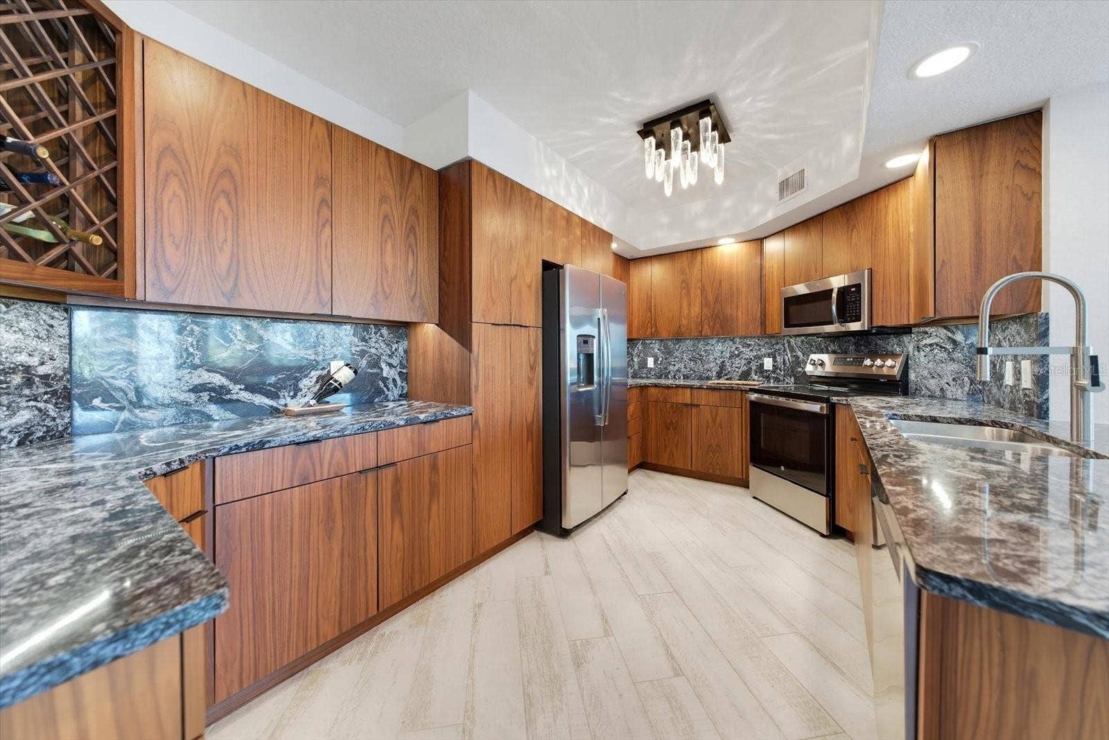 1170 GULF BOULEVARD, #404, Clearwater Beach, FL 33767 Designer kitchen featuring custom light & cabinetry offers ample & efficient storage.