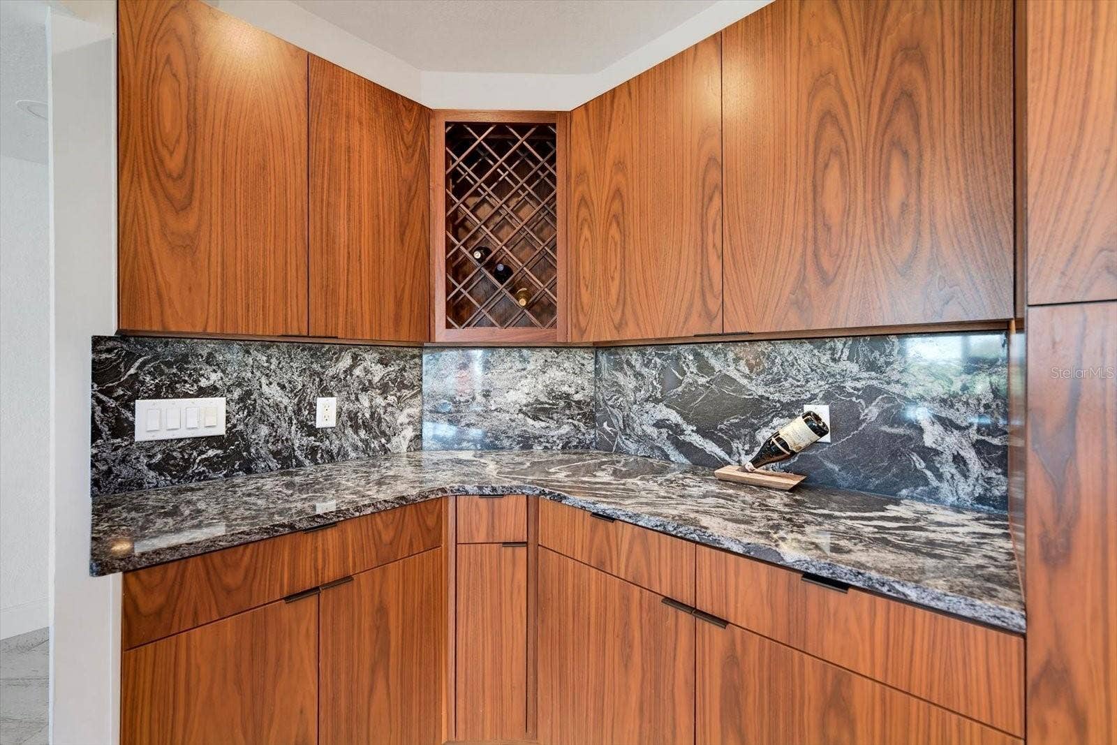1170 GULF BOULEVARD, #404, Clearwater Beach, FL 33767 Note the beautiful walnut veneer cabinets & wine rack.